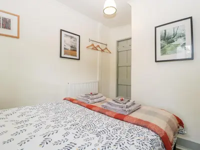 a bedroom with a bed with towels on it at 7 Bell Street in Talgarth