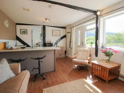 a living room with a couch and a table at The Old Beams at Pont y Forwyn in Llansantffraid-ym-Mechain