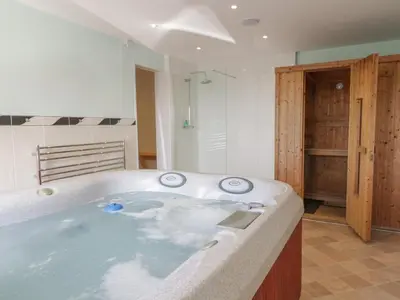 a large bath tub in a bathroom at Awel Y Llan in Llanfair
