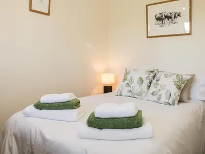 a bedroom with a bed with towels on it at Clun Forest Cottage in Monkhopton