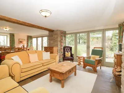 a living room with a couch and a table at Timber Barn in Eardisland