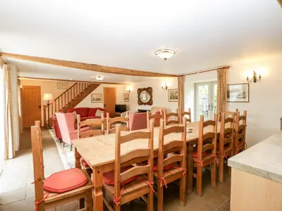 a dining room with a wooden table and chairs at Timber Barn in Eardisland
