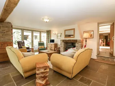 a living room with two couches and a fireplace at Timber Barn in Eardisland
