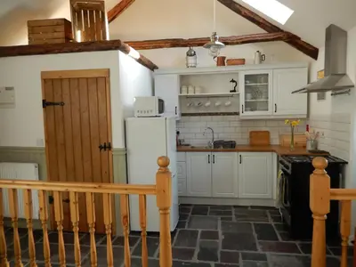 a kitchen with a white refrigerator and a counter at Tanyresgair Cottages in Aberystwyth
