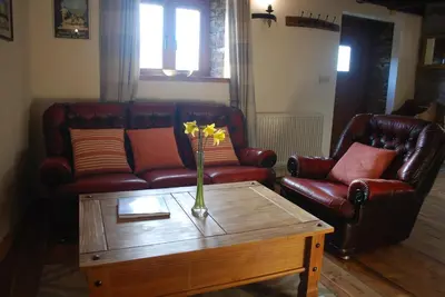 a living room with a couch and a coffee table at Tanyresgair Cottages in Aberystwyth