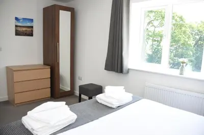 a bedroom with a bed with white towels on it at Maen Llwyd in Llanyre
