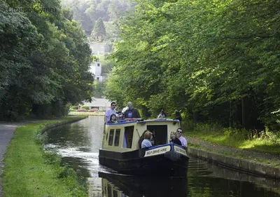 a group of people on a boat on a canal at Bwthyn Bryn yr Aber in Bala