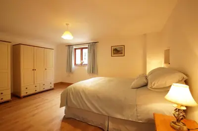 a bedroom with a large bed and a window at Degwm in Llanwrin