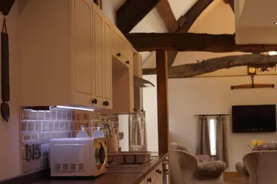 a kitchen with a microwave on top of a counter at Degwm in Llanwrin