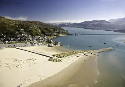 an aerial view of a beach with people in the water at Hafod in Llanddwywe