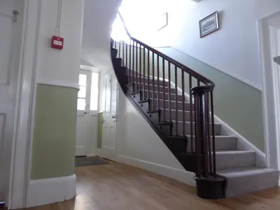 a staircase in a home with a black rail at The Grange Guest House in Brecon