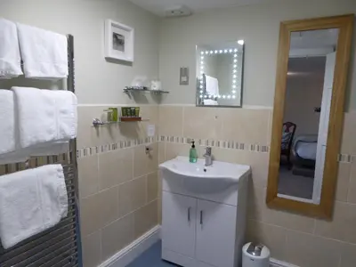 a bathroom with a sink and a mirror at The Grange Guest House in Brecon