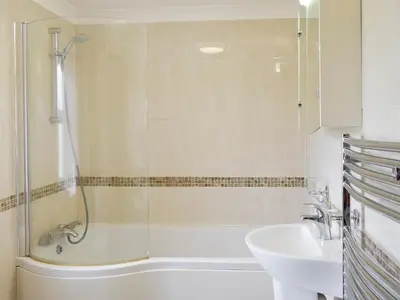 a bathroom with a shower and a tub and a sink at No 2 Pegraig Draw - Uk6435 in Llanychaiarn
