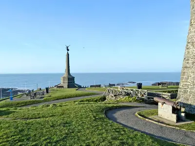 a path leading to a monument with the ocean in the background at No 2 Pegraig Draw - Uk6435 in Llanychaiarn