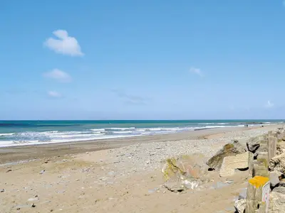 a beach with a fence and the ocean at No 2 Pegraig Draw - Uk6435 in Llanychaiarn