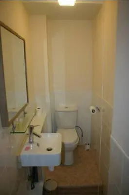 a bathroom with a toilet and a sink and a mirror at The Vaults in Shrewsbury