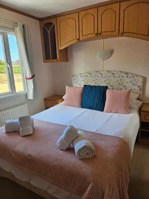 a bedroom with a bed with towels on it at Ruth's Repose Country Retreat with private hot tub & Stunning Views in Shrewsbury