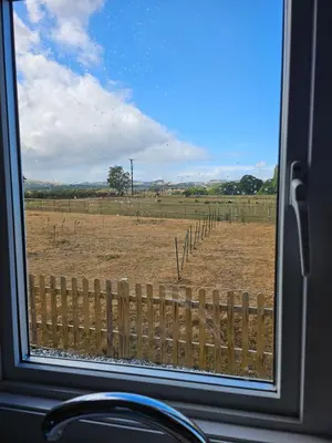 a window with a view of a field with a fence at Ruth's Repose Country Retreat with private hot tub & Stunning Views in Shrewsbury