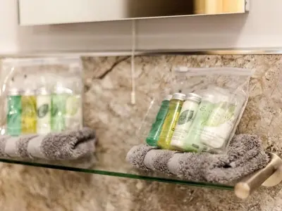 a glass shelf in a kitchen with bottles on it at Parkers House Bed & Breakfast in Newtown