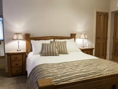 a bedroom with a large bed with two night stands at Parkers House Bed & Breakfast in Newtown