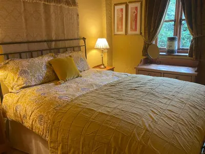 a bedroom with a bed and a lamp and a window at The Old Dairy in Shrewsbury