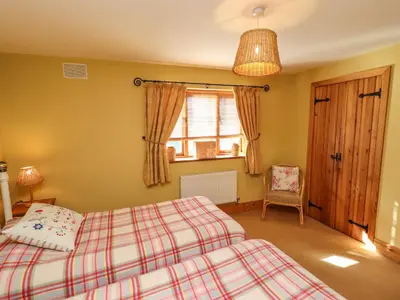 a bedroom with two beds and a window at The Granary in Shrewsbury