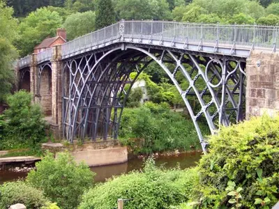 a bridge over a river with a train on it at The Byre in Bishops Castle