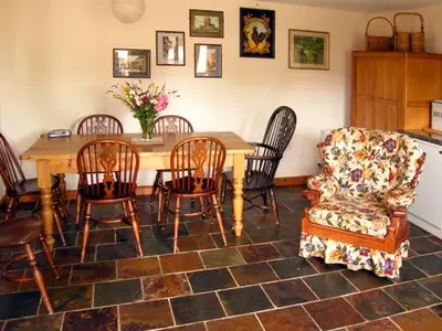 a living room with a table and chairs and a couch at The Coach House in Shrewsbury