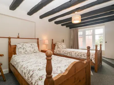 a bedroom with two beds and a window at The Croft in Vowchurch