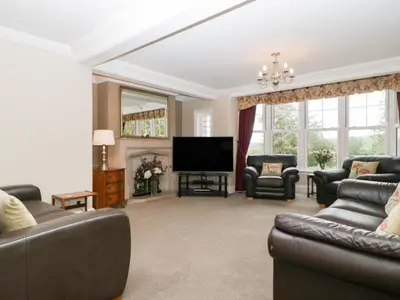 a living room with couches and a flat screen tv at The Croft in Vowchurch