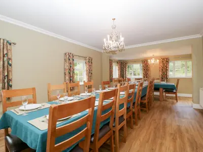 a dining room with a long table and chairs at The Croft in Vowchurch