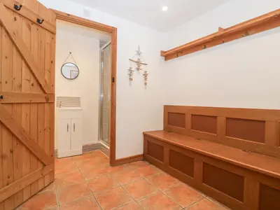 a room with a wooden bench and a door at The Croft in Vowchurch