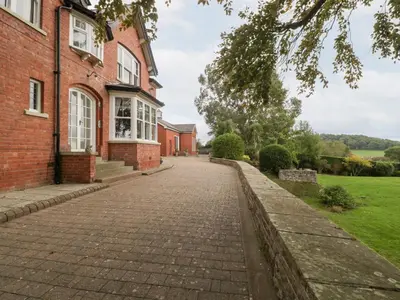 an empty brick road in front of a brick building at The Croft in Vowchurch