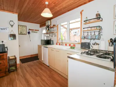 a kitchen with a stove and a counter top at The Log Cabin in Adforton