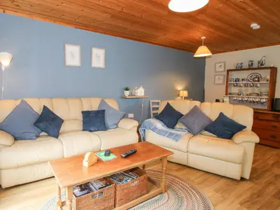 a living room with two couches and a coffee table at The Log Cabin in Adforton