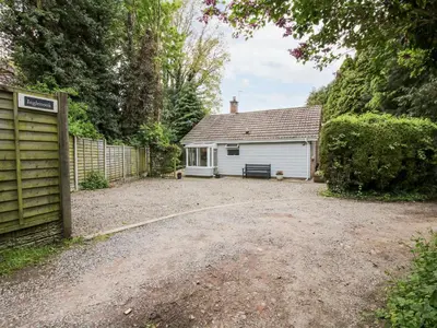 a house with a garage and a gravel driveway at Inglenook in Ludlow