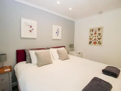 a bedroom with a large white bed with pillows at Inglenook in Ludlow