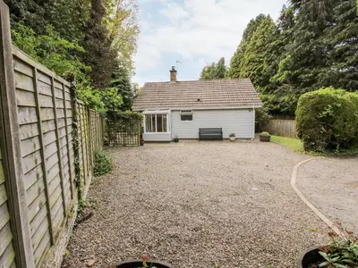 a house with a fence and a yard at Inglenook in Ludlow