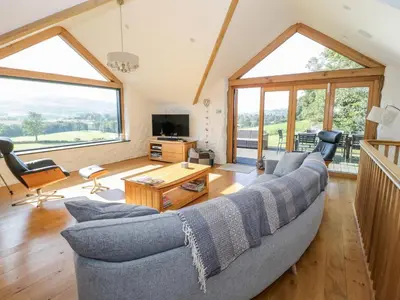a living room with a couch and a table at Tyn Llwyn in Gwyddelwern