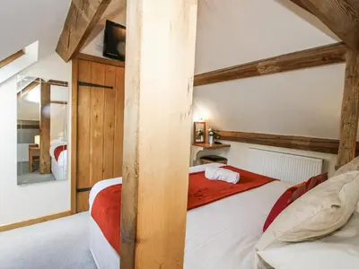 a bedroom with a bed in a room at The Milking Parlour in Craven Arms