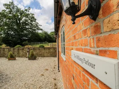 a brick building with a sign on the side of it at The Milking Parlour in Craven Arms