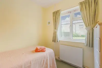 a bedroom with a bed and a window at Meadow Lea in Leominster