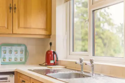 a kitchen counter with a sink and a window at Meadow Lea in Leominster