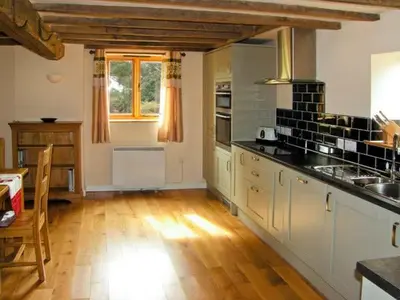 a kitchen with a table and a counter top at The Old Cider Mill in Farden