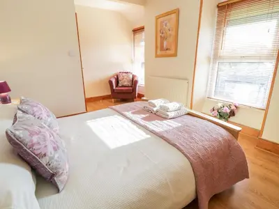 a bedroom with a bed with two towels on it at Tyddyn in Dyffryn