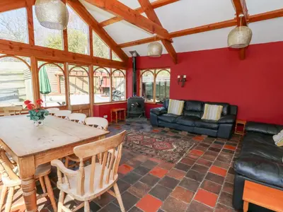 a living room with a table and a couch at The Farmhouse in Ciliau-Aeron
