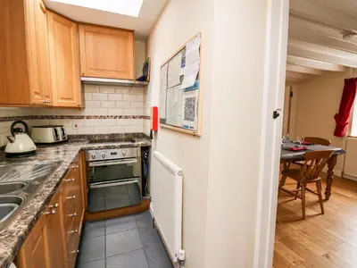 a kitchen with a sink and a stove top oven at Penlon in Aberystwyth