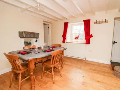 a dining room with a table and chairs at Penlon in Aberystwyth