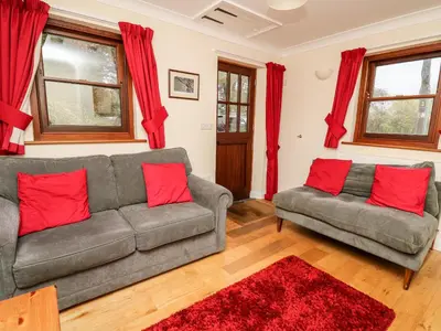 a living room with two couches and red pillows at Penlon in Aberystwyth