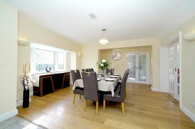 a dining room with a table and chairs at Lower Lodge in Cardeston